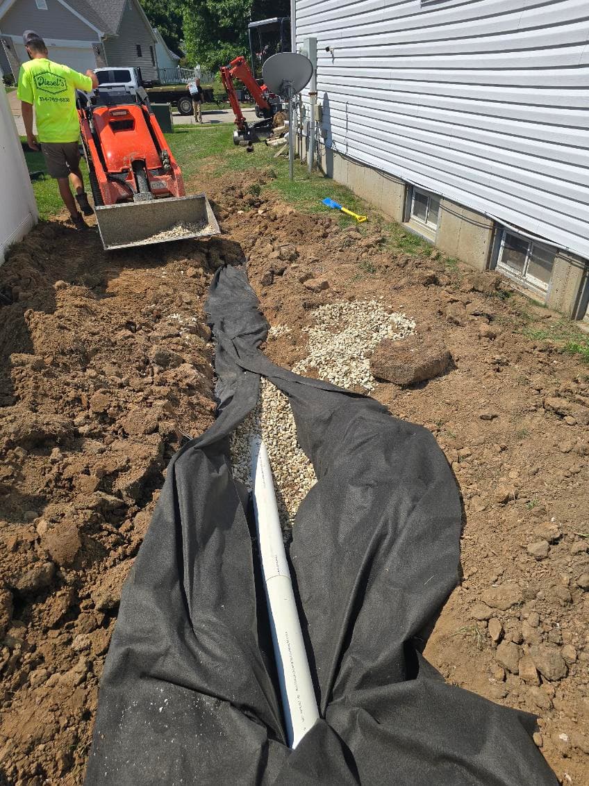 Efficient French Drain Installation with Decorative Rock image
